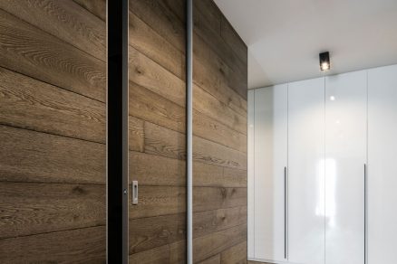 Shodná dřevěná dýha se prolíná na podlaze stěně i na dveřích MASTER DOOR sahajících od podlahy až ke stropu ve stavebním pouzdře AKTIVE.