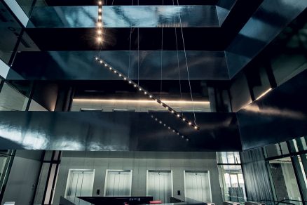 Do atria kancelářské budovy proniká světlo skrze prosklený strop.