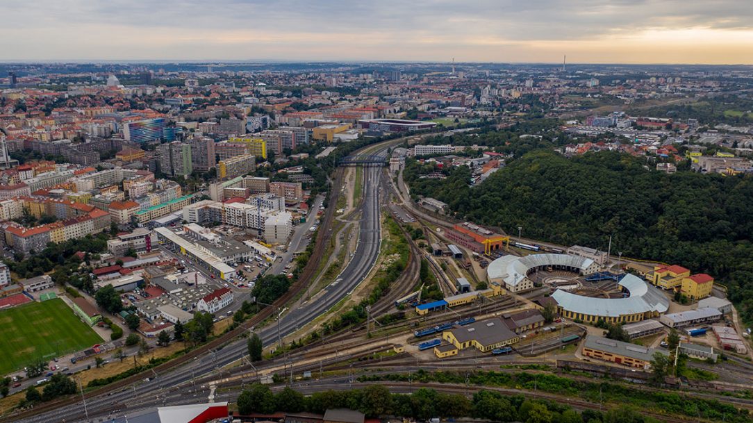 Pohled k Edenu. Původní trať Hostivař – Vršovice (vlevo), nové zaústění tratí Vršovice – Krč, odstavné nádraží jih a depo Praha (vpravo)