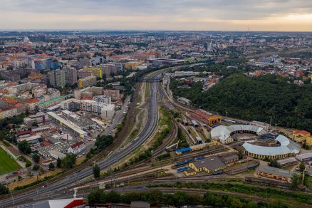 Pohled k Edenu. Původní trať Hostivař – Vršovice (vlevo), nové zaústění tratí Vršovice – Krč, odstavné nádraží jih a depo Praha (vpravo)