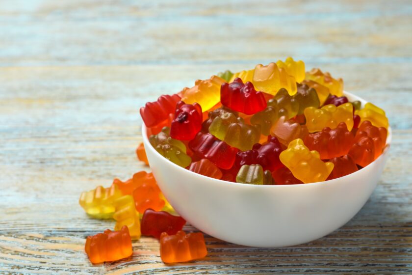 Bowl,With,Delicious,Bright,Jelly,Bears,On,Wooden,Table,,Space