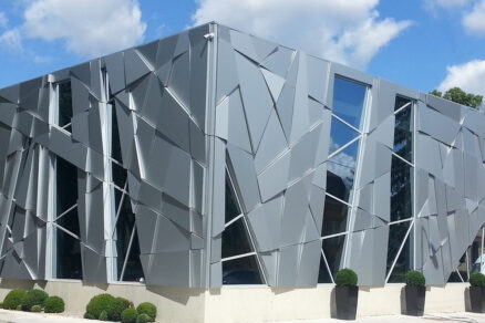 Designová hliníková provětrávaná fasáda AVG s geometrickým vzorem na moderní budově.