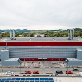 Pohled na zrekonstruovaný zimní stadion Pavla Demitry v Trenčíně s novou fasádou a střešními technologiemi