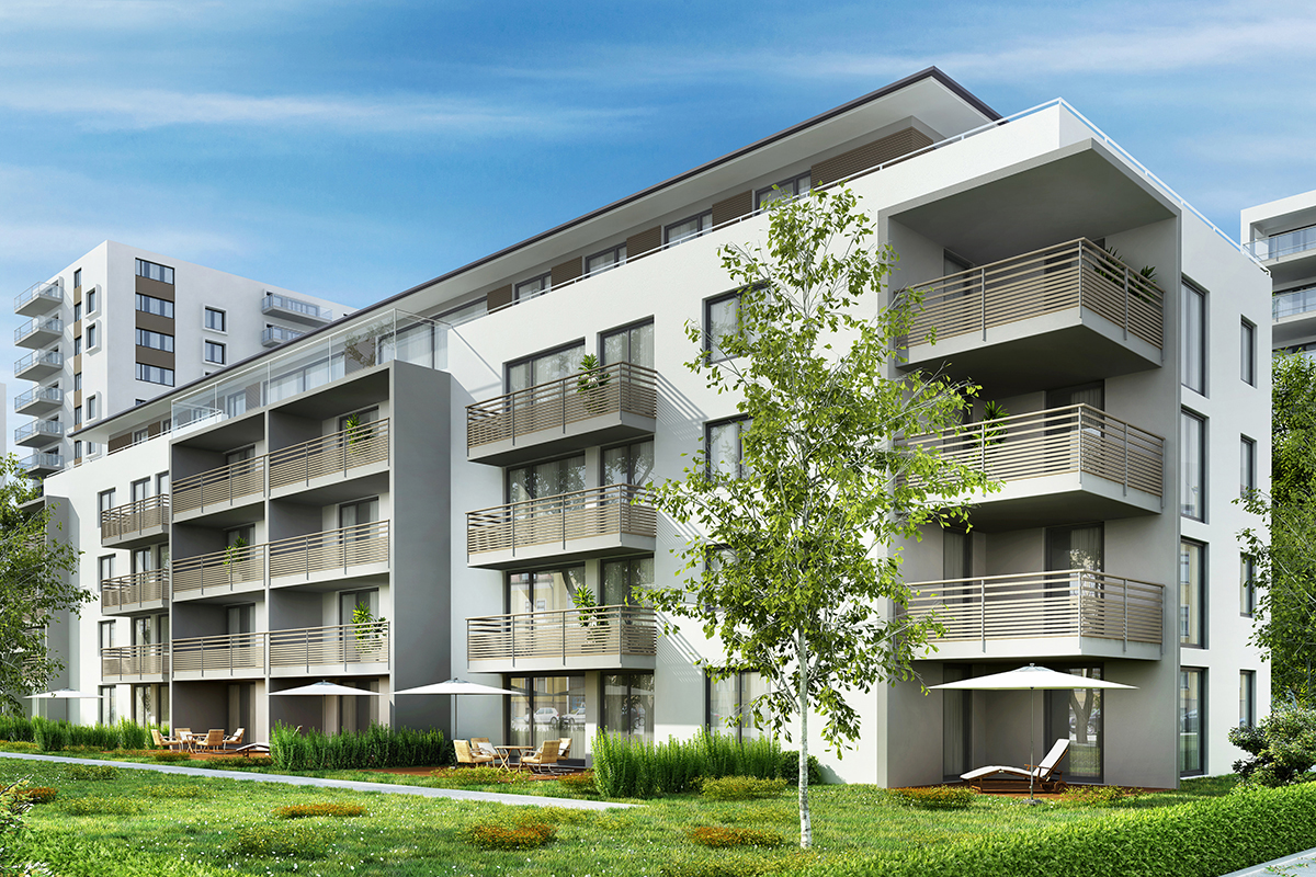 Současný bytový dům s balkony a zelenou plochou před objektem