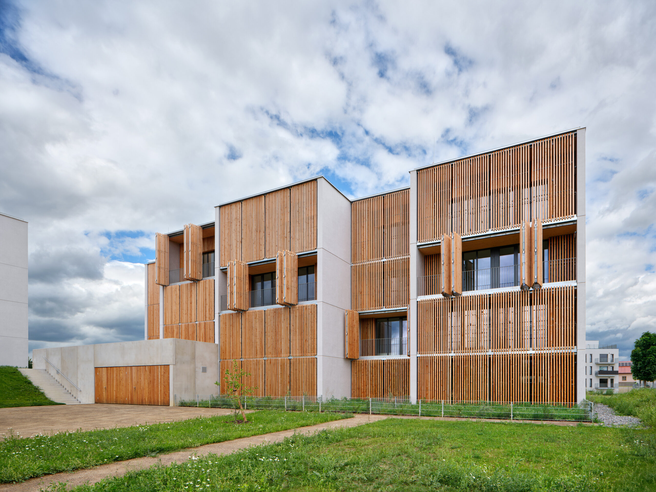 Fasáda s lodžiemi a dřevěnými okenicemi