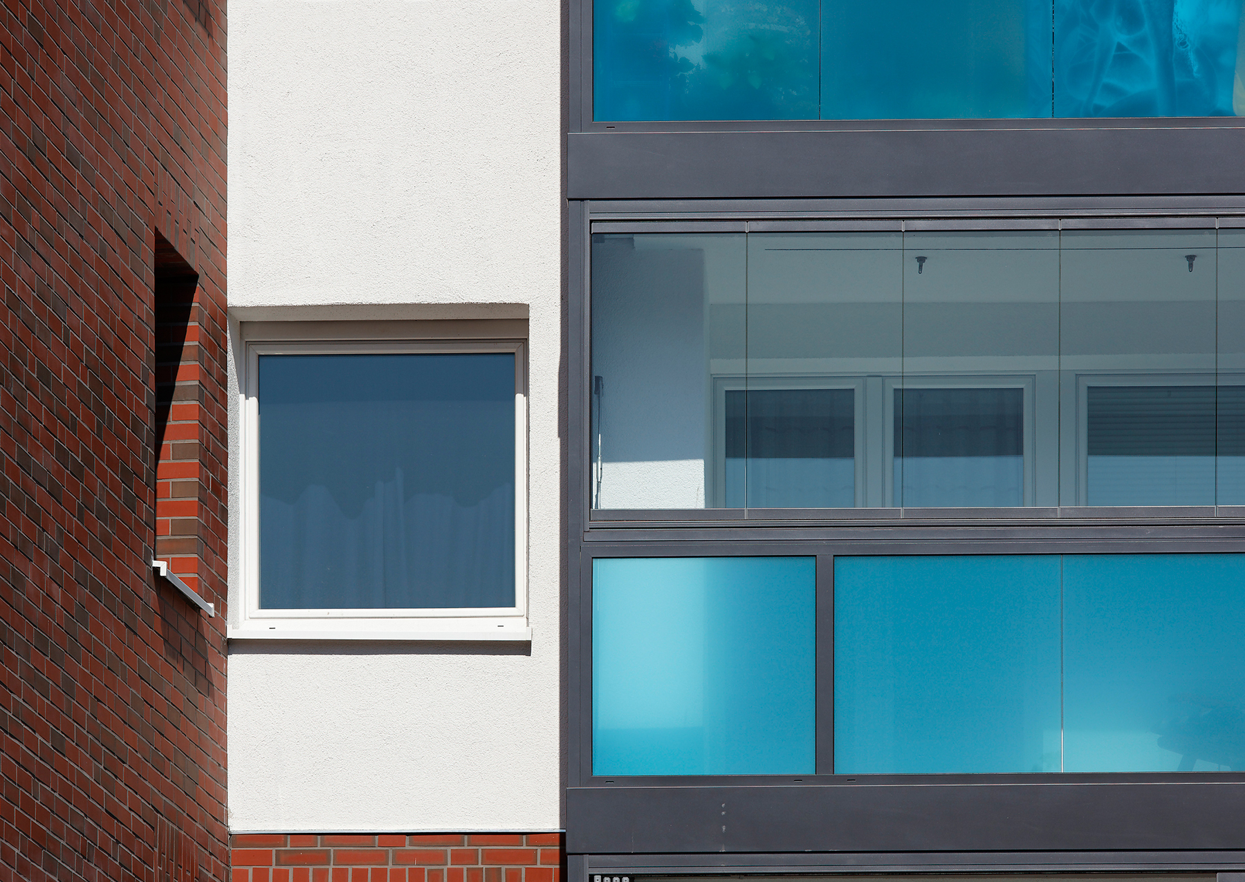 Schüco balkony, vyplněné bodově uchycenými skly VSG s barevnými fóliemi, byly nad úrovní zábradlí kombinovány se skládacím zasklením, poskytujícím ochranu před nepříznivým počasím.