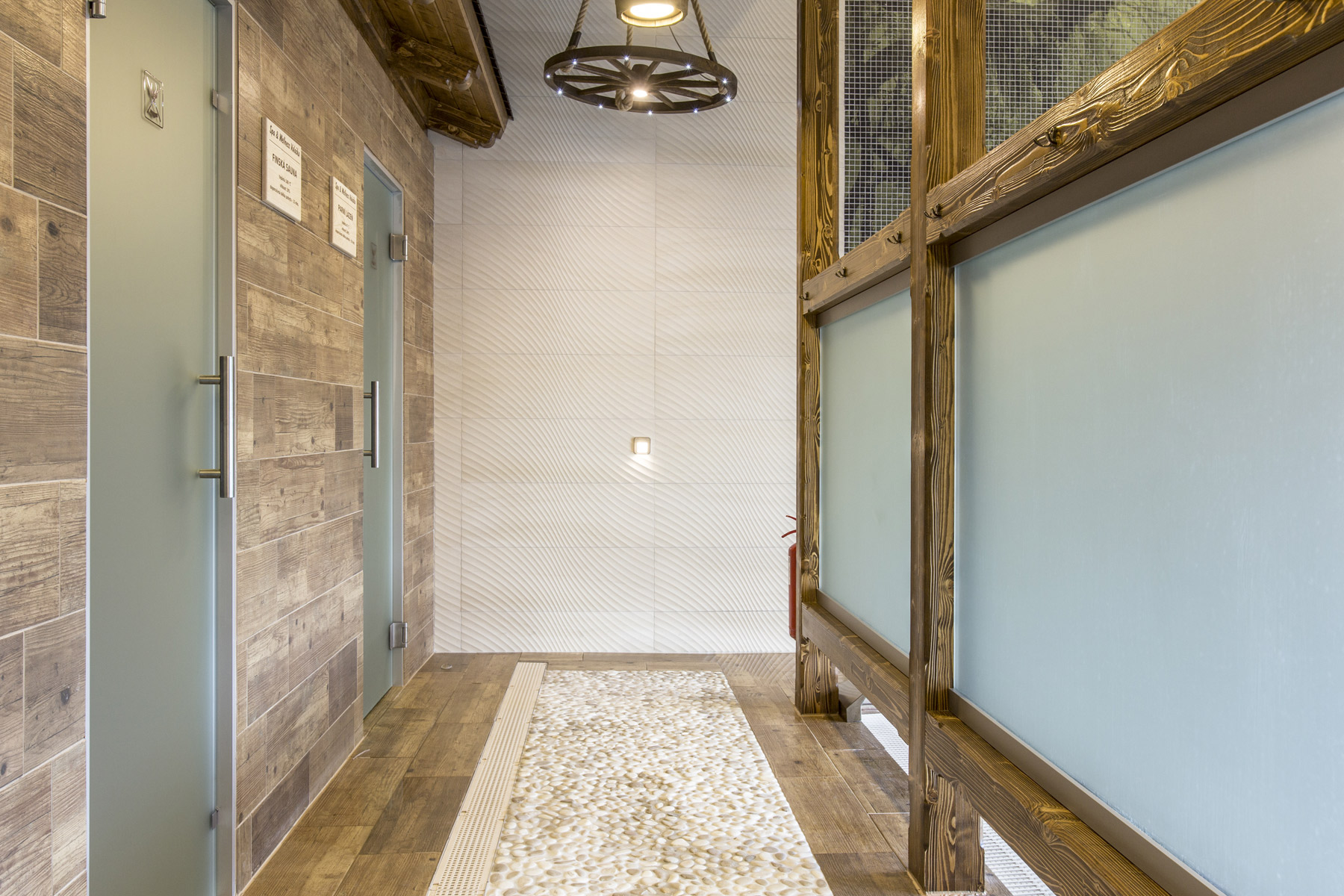 Skleněné stěny před saunou a parní lázní jsou vyrobeny ze skla satináto.